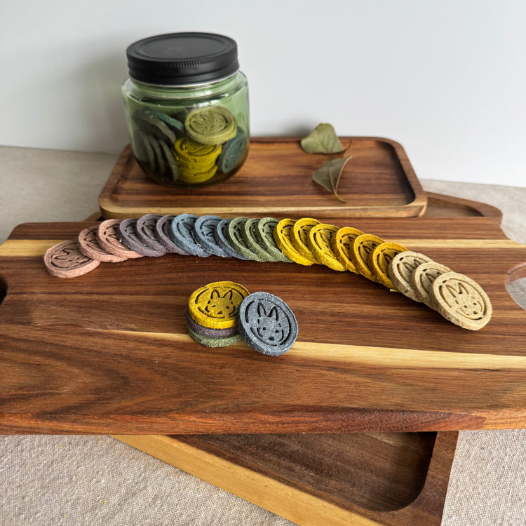 Colorful botanical rabbit wellness biscuits from BunBun & Co arranged on wooden board with herbal bunny treats in glass jar