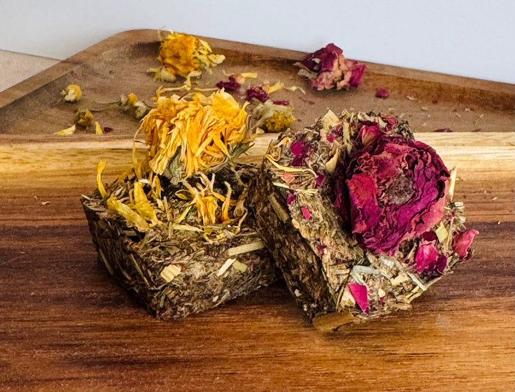 Botanical digestive forage bites for rabbits on a wooden board made with plantain, dandelion, and chamomile,calendula and rose buds