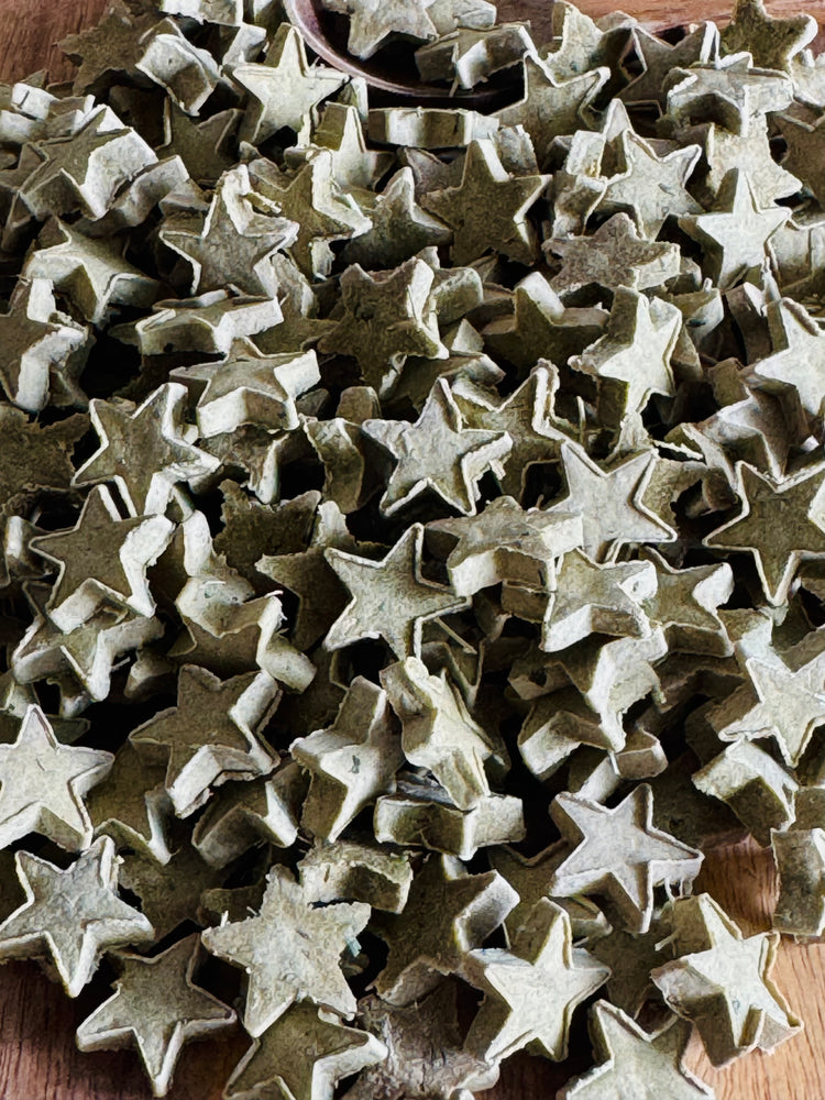 Collection of star-shaped rabbit treats on a wooden surface