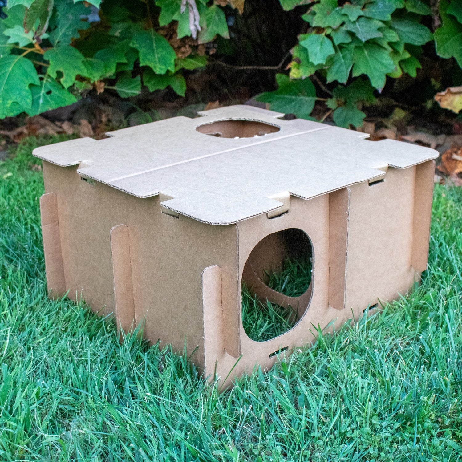 One assembled section of the Mini Haven cardboard rabbit hide playhouses displayed on grass
