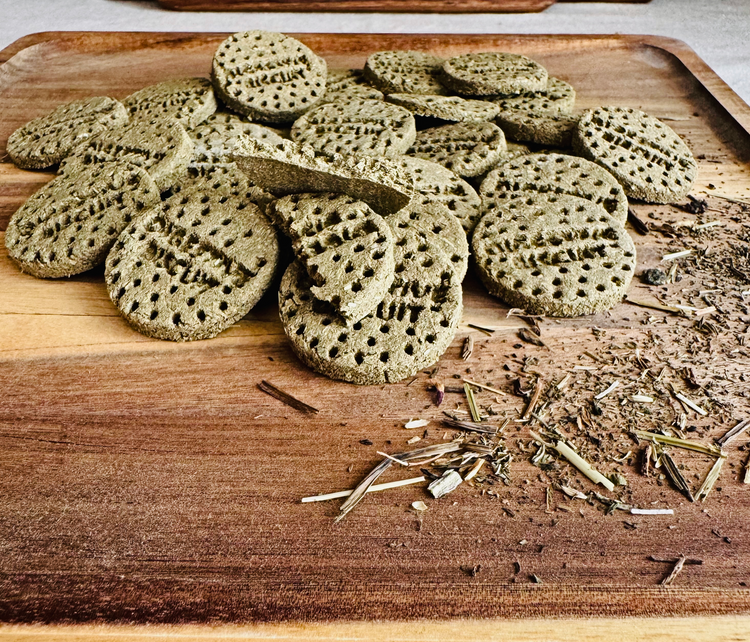 Handcrafted rabbit digestive biscuits showing crumb texture with visible herbal ingredients on wooden board