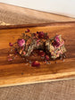 Handmade botanical forage bars for rabbits with dried herbs, flowers, and hay-based ingredients on linen cloth nad wooden board