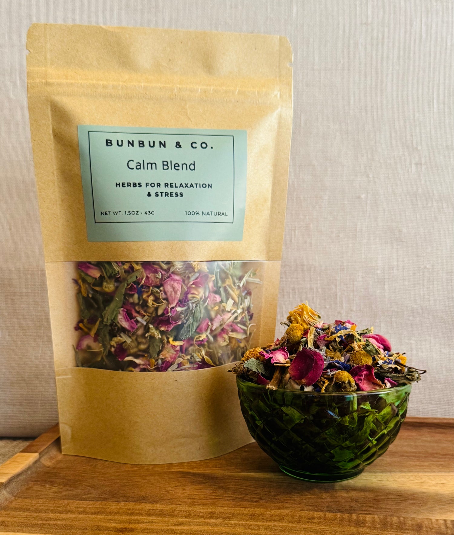 Bunbun & Co. Calm Blend rabbit forage package with a bowl of forage on a wooden surface.