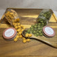  Yellow and green star-shaped rabbit treats spilling from clear apothecary jars onto wooden tray with wodden spoon