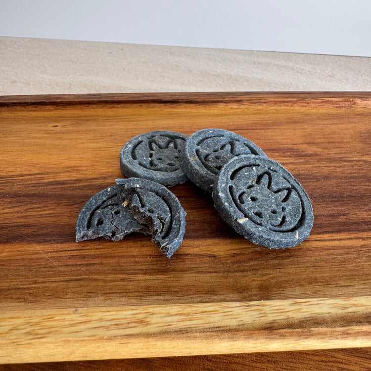 Blue botanical rabbit biscuit for skin and coat support from BunBun & Co
with broken biscuit to show texture