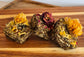 Botanical digestive forage bites for rabbits on a wooden board made with plantain, dandelion, and chamomile,calendula and rose buds