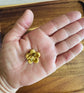 A close up of BunBun & Co. Strawberry Carrot Blossom rabbit treats in a persons hand to show scale.
