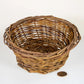 Woven willow basket displayed on white background with coin for size reference
