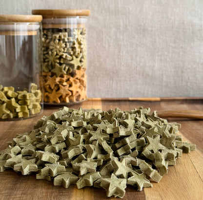 Star-shaped rabbit treats on a wooden surface with glass jars in the background.