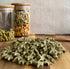 Star-shaped rabbit treats on a wooden surface with glass jars in the background.