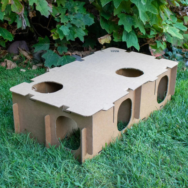 Large Maze Haven cardboard rabbit hide maze showing circular entrances and assembled structure on grass