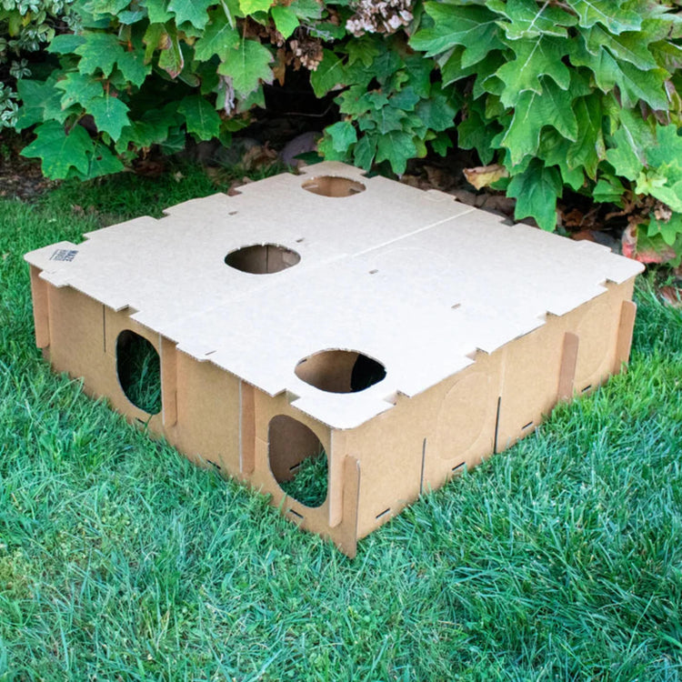 Large Maze Haven cardboard rabbit maze hide assembled with connected sections displayed on grass