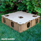 Large Maze Haven cardboard rabbit hide and enrichment maze assembled on grass with foliage background