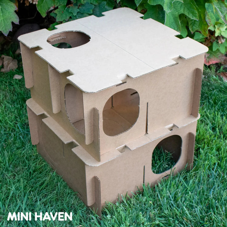 Cardboard Mini Haven rabbit maze playhouse showing interior compartments and entrances on grass